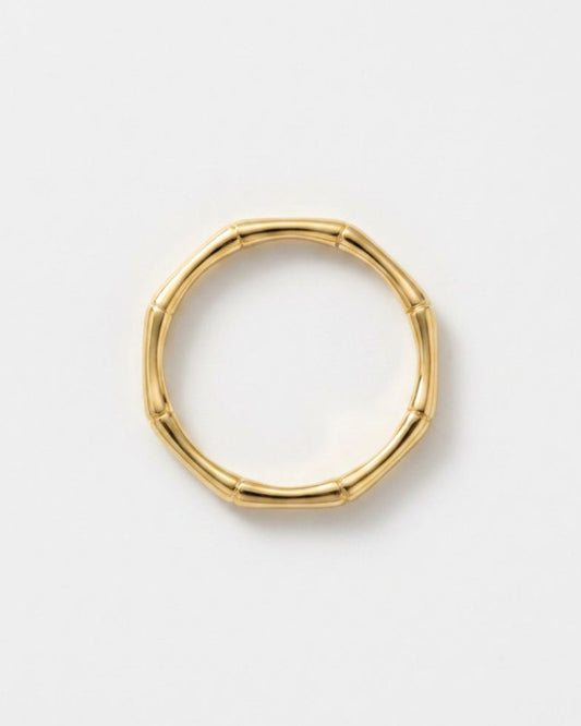 A gold-toned segmented bangle ring with a natural bamboo-inspired design, shown on a clean white background.