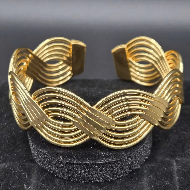 Braid Cuff Bangle in Gold finish on a neutral background