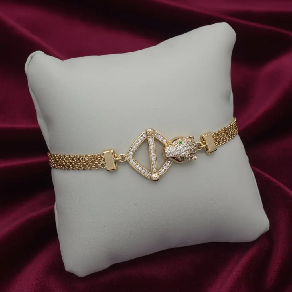 Golden Leopard bracelet on a white cushion against a red satin background