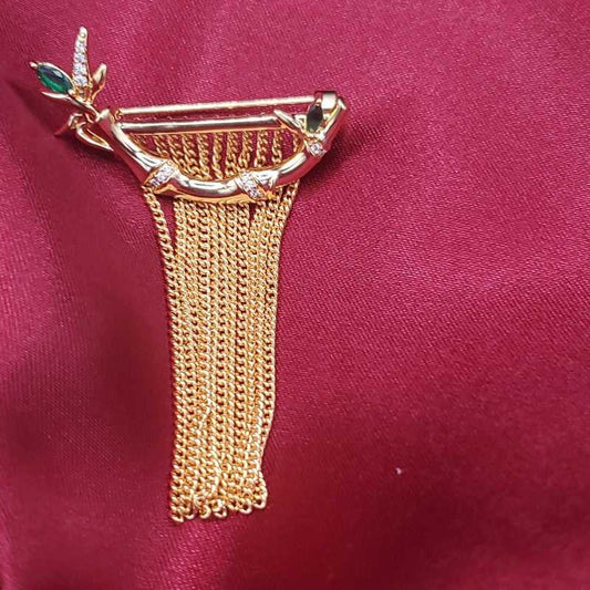 Bamboo Branch Brooch in Gold finish, with cubic zirconia stone on a neutral background