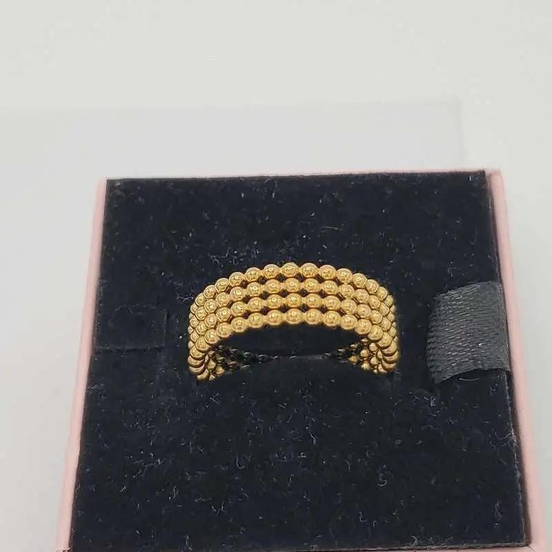 Beads wedding Ring in Gold finish on a neutral background