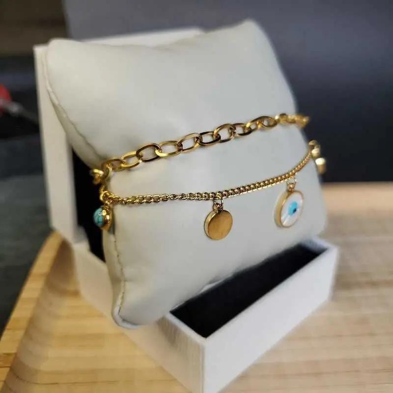 Classic Evil Eye Bracelet in Gold finish, with turquoise stone on a neutral background