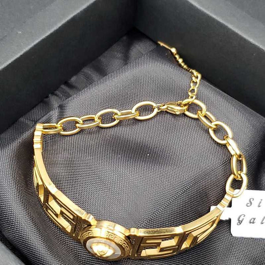 Classic Greek Key Bangle in Gold finish on a neutral background
