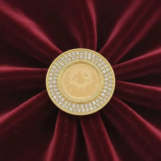 Classic Lira Coin Ring in Gold finish, with cubic zirconia stone on stones on a red velvet background