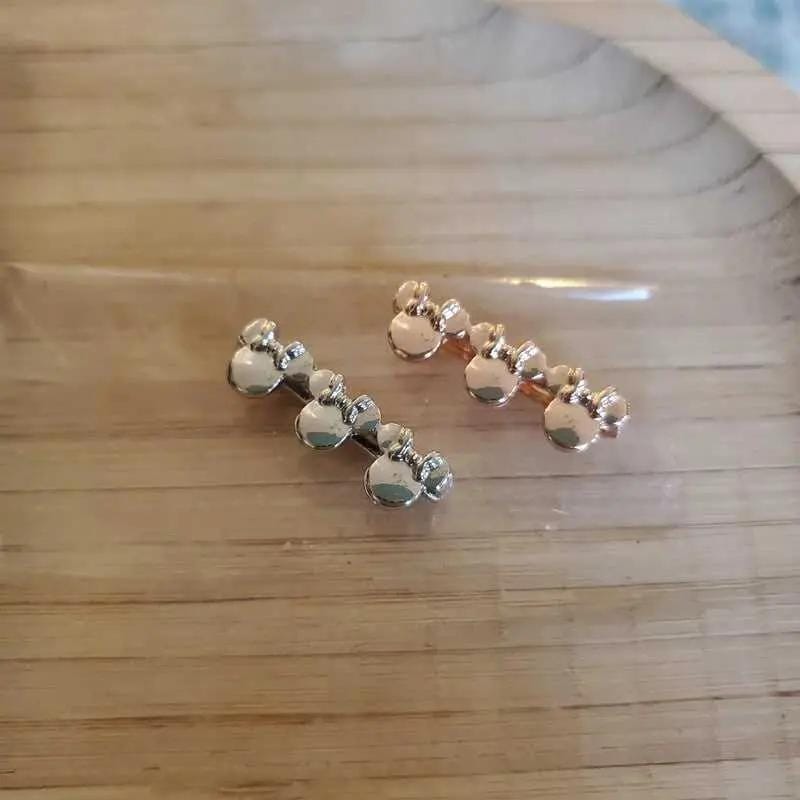 Classic Minnie Mouse Charms in Gold and Silver finish on a neutral background