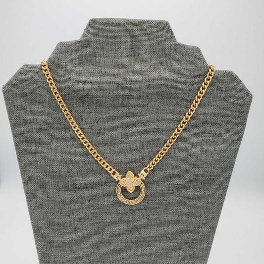 Clover Four Leaves Necklace in Gold finish, with cubic zirconia stone on a neutral background