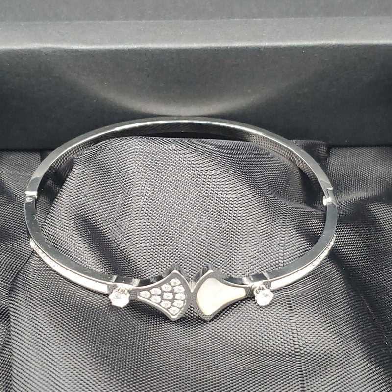 Diva's Dream Bangle in Gold finish, with cubic zirconia stone on a neutral background