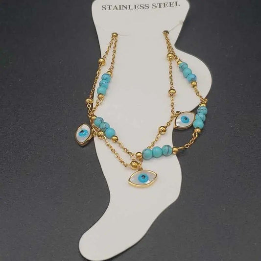 Evil Eye Anklet in Gold finish, with turquoise stone on a neutral background