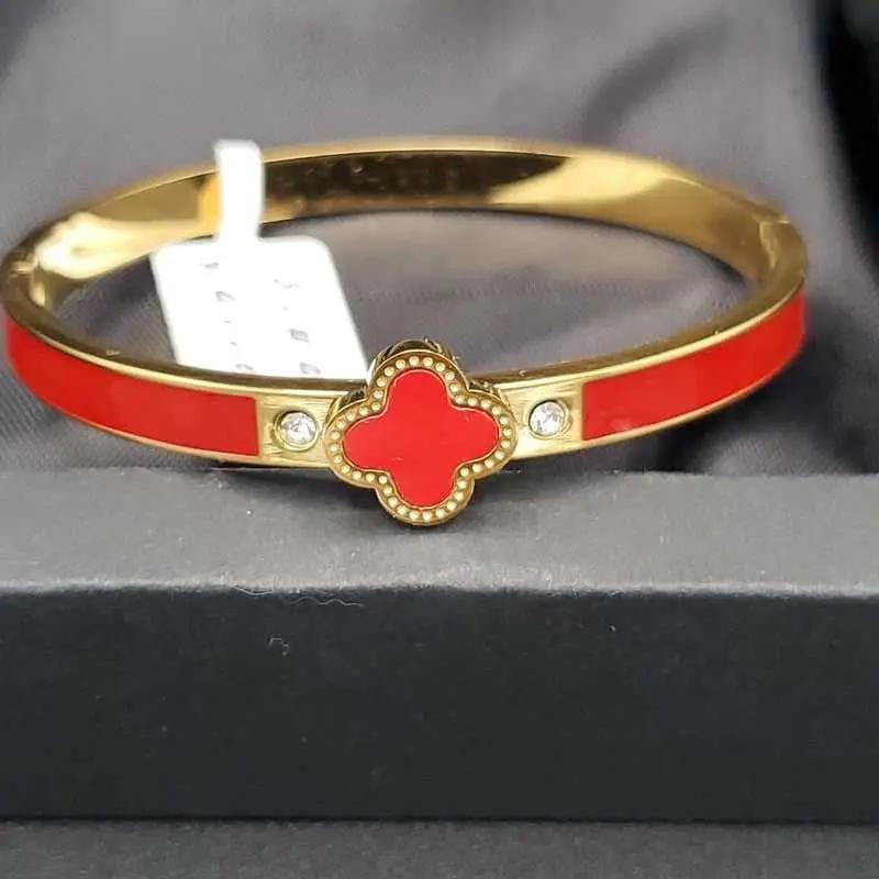 Graceful Clover Bangles in Gold finish on a neutral background