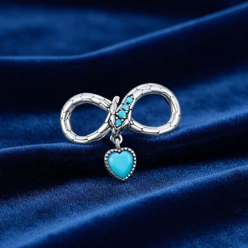 Infinity Snake Charm in Silver finish, with turquoise stone on a neutral background