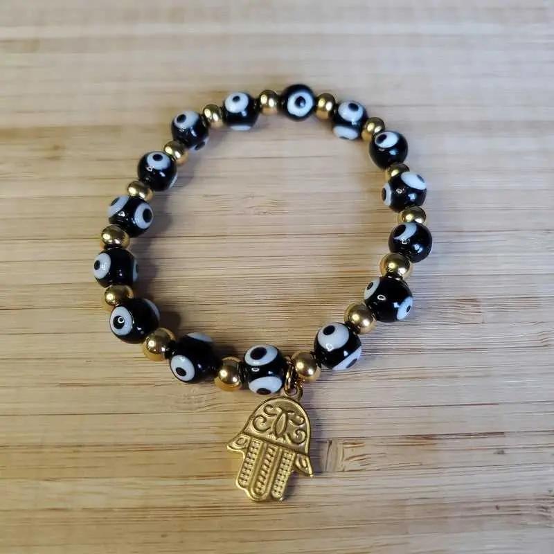 Modern Evil Eye Bracelet in Gold finish on a neutral background