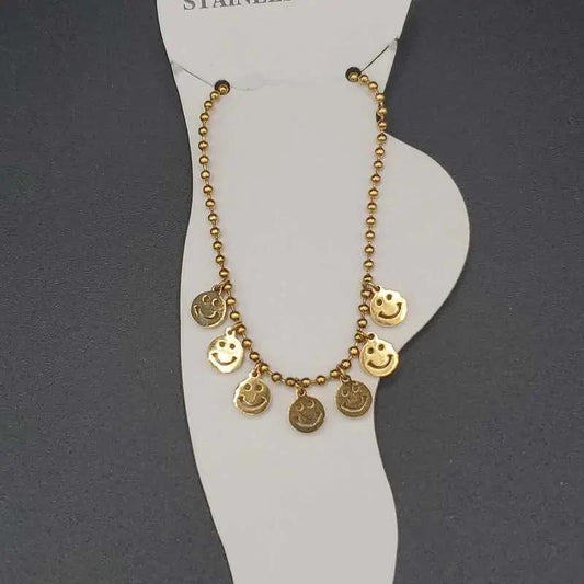 Modern Happy Face Anklet in Gold finish on a neutral background