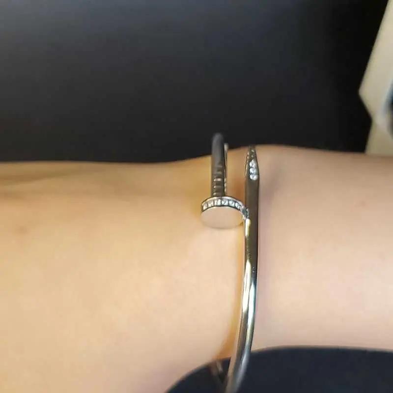 Modern Stones Nail Bangle in Silver finish, with cubic zirconia stone on stones on a wrist