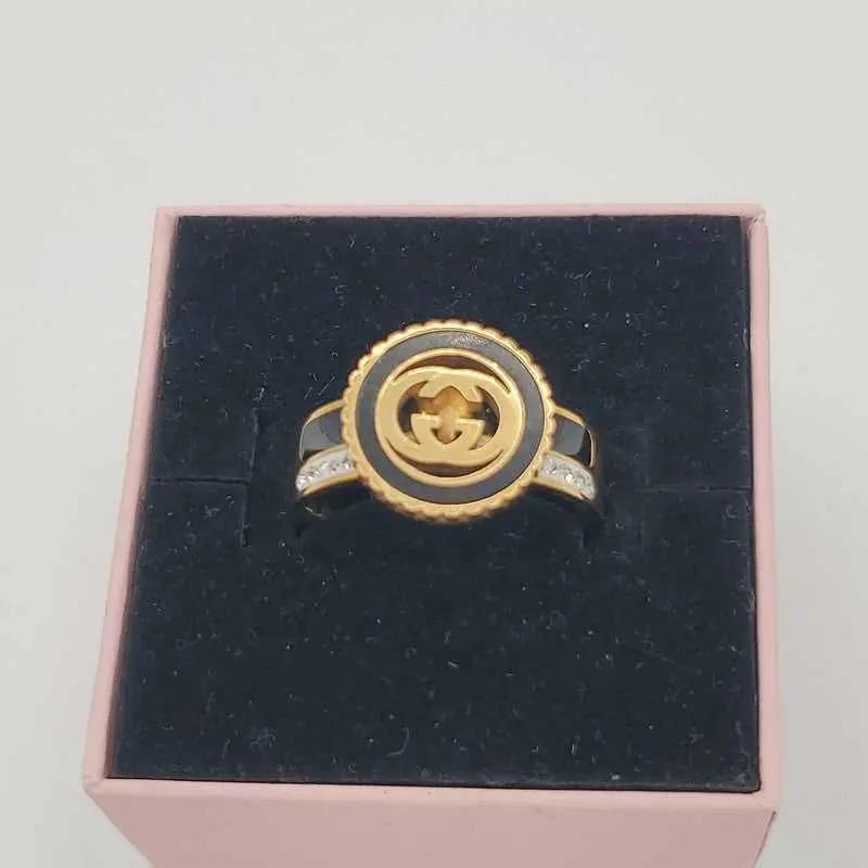 Signature Design Ring in Gold finish, with cubic zirconia stone on shoulder stones
