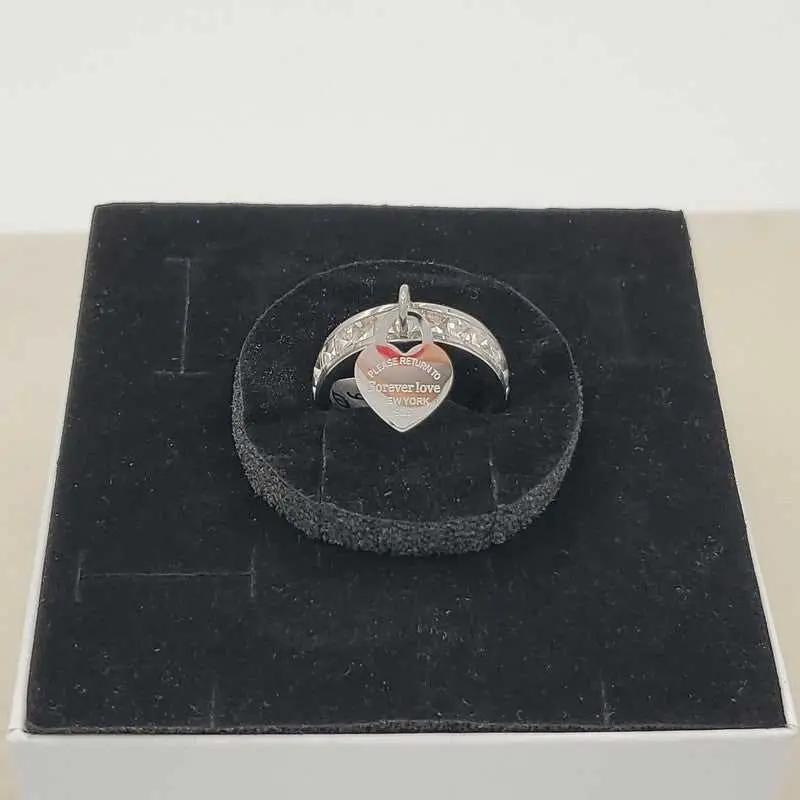 Signature Heart Ring in Silver finish, with cubic zirconia stone on a neutral background