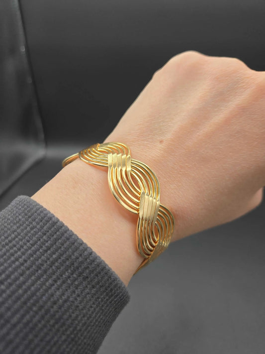 Braid Cuff Bangle in Gold finish on a wrist