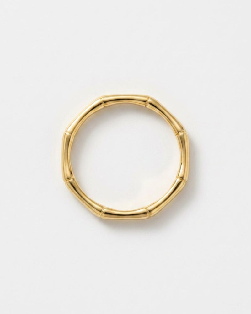 A gold-toned segmented bangle ring with a natural bamboo-inspired design, shown on a clean white background.