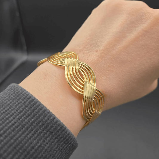 Braid Cuff Bangle in Gold finish on a wrist