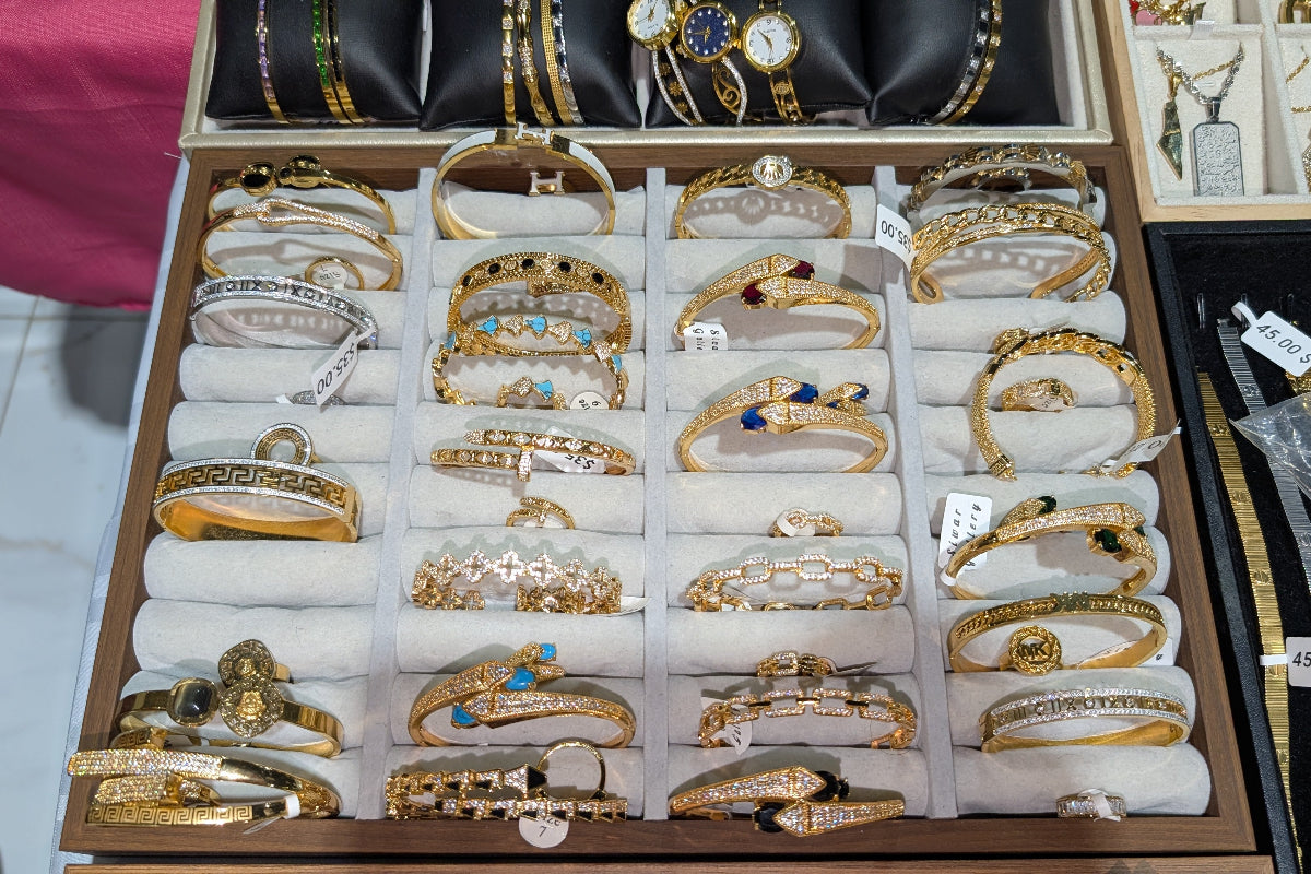 Collection of gold bangles in a display case