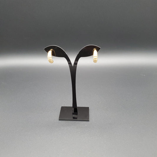 This image features a pair of sophisticated earrings, crafted from stainless steel with a glossy finish. The design is minimalist, with each earring extending from a sleek, black, rectangular base that supports a graceful, arched hook.