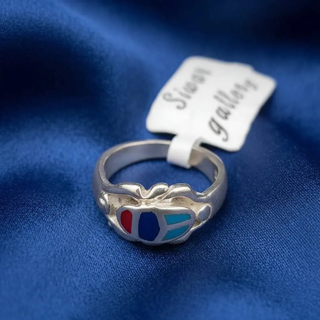 Egyptian Scarab sterling 925 Silver ring with colorful design on a blue fabric background