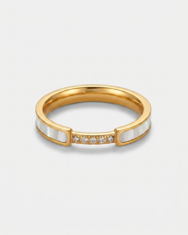 A gold ring with a double row of white inlay panels and a row of small clear stones in the center, shown on a light gray background.