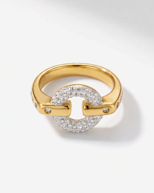 A gold ring featuring a circular pavé diamond center with two curved gold bars extending outwards, each adorned with small accent diamonds, shown on a light gray background.