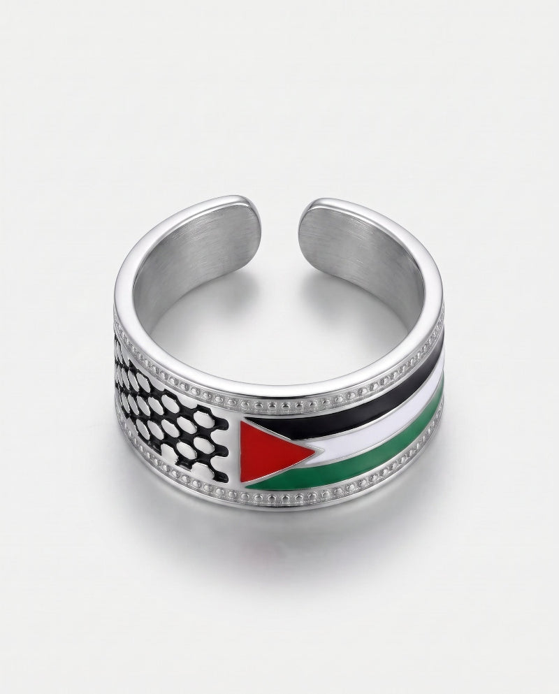 A silver-toned open cuff ring featuring an inlay of the Palestinian flag, including black, white, green, and red stripes with a red triangle, set against a clean white background.