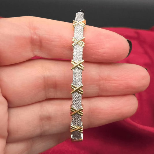 Signature Sixteen Stone Bangle in Gold and Silver finish, with cubic zirconia stone on stones set in a 'X' pattern