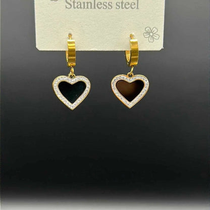 Artisanal Heart Earrings in Gold finish, with cubic zirconia stone on a neutral background