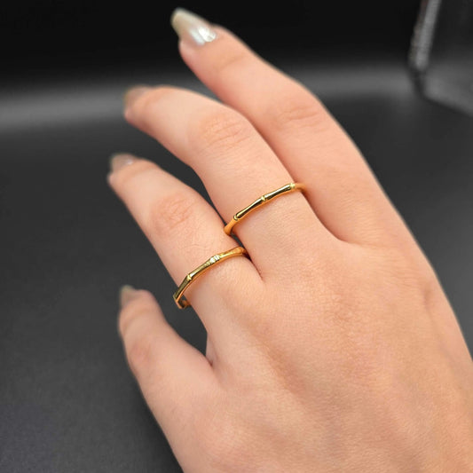 Bamboo ring in Gold finish, with cubic zirconia stone on a hand, one with a small clear stone accent