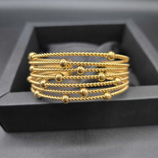Beads Bangle Cuff in Gold finish on a neutral background