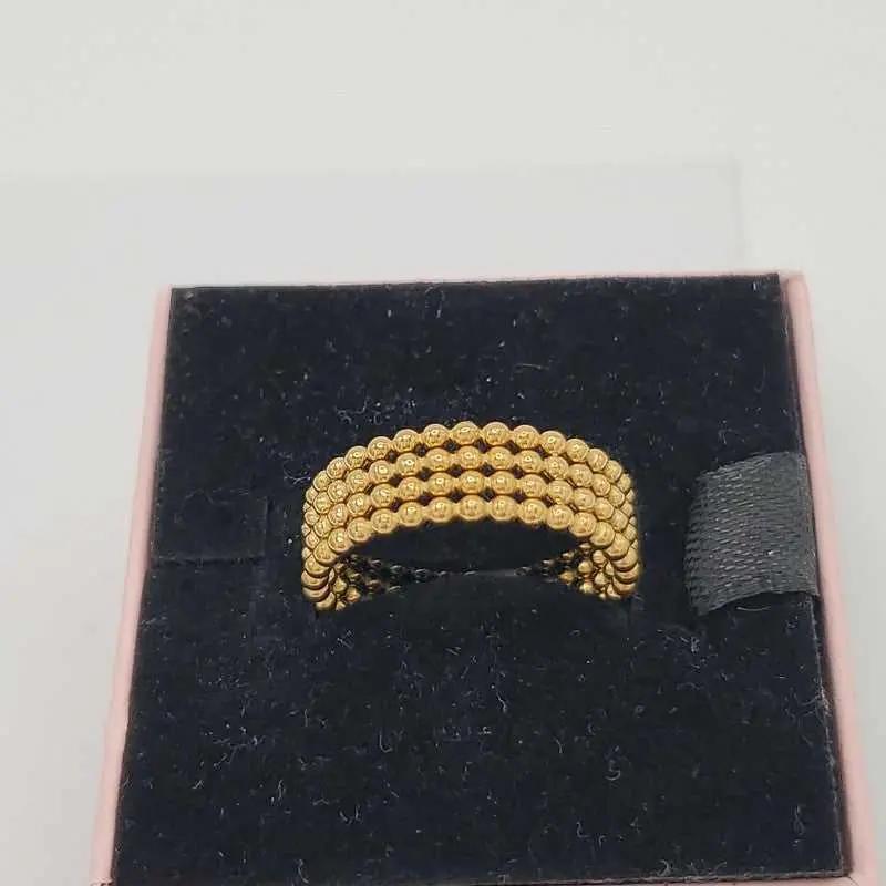 Beads wedding Ring in Gold finish on a neutral background