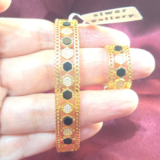 Beehive Bangle with Black Enamel and Zircons in Gold finish, with cubic zirconia stone on a neutral background