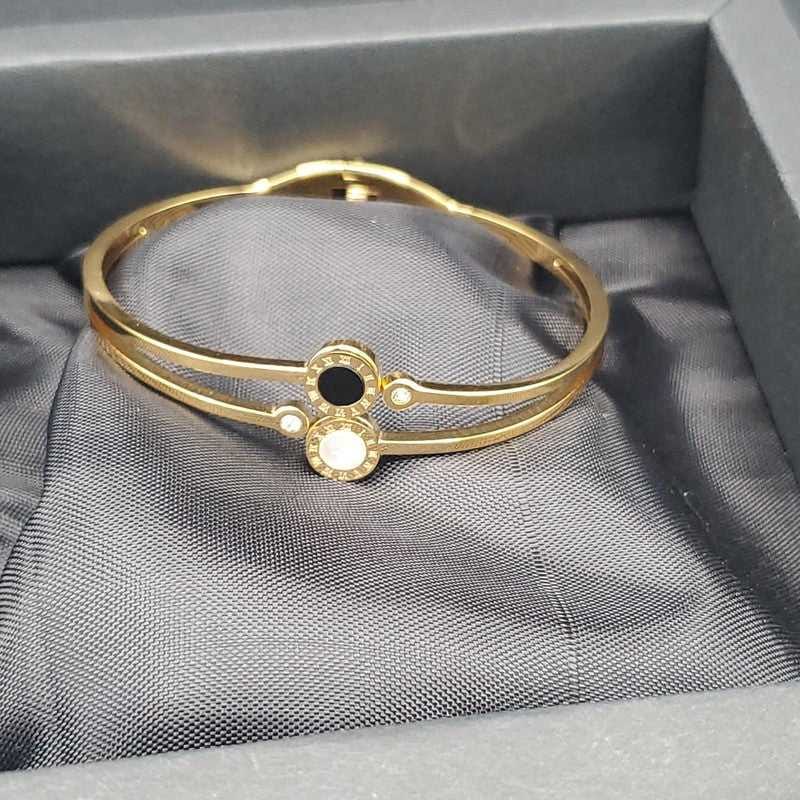 Black & White Italian Bangle in Gold finish on a neutral background
