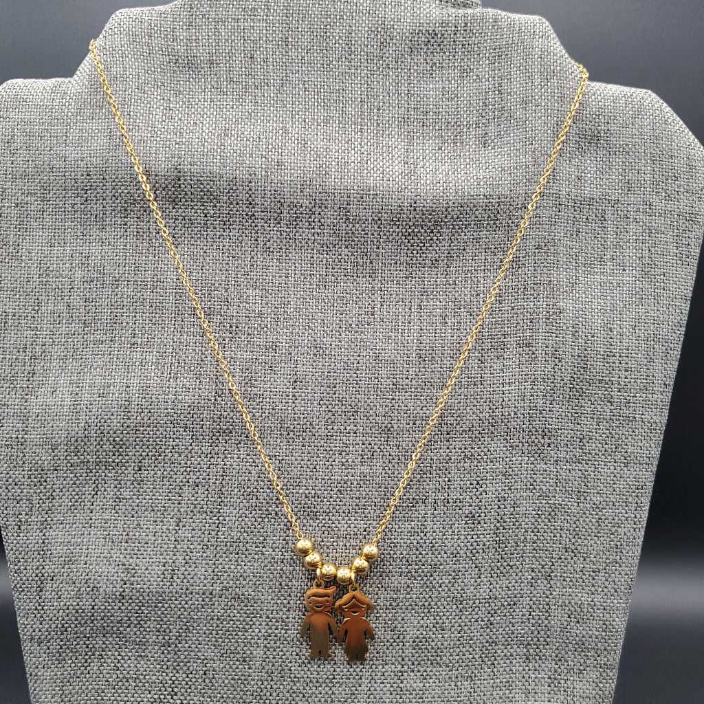 Boy & Girl Necklace in Gold finish on a neutral background