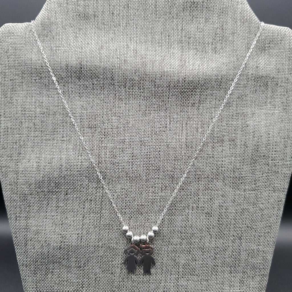 Boy & Girl Necklace in Gold finish on a neutral background