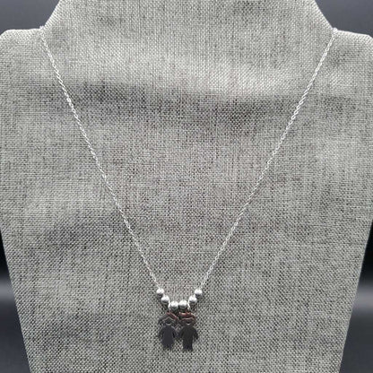 Boy & Girl Necklace in Gold finish on a neutral background