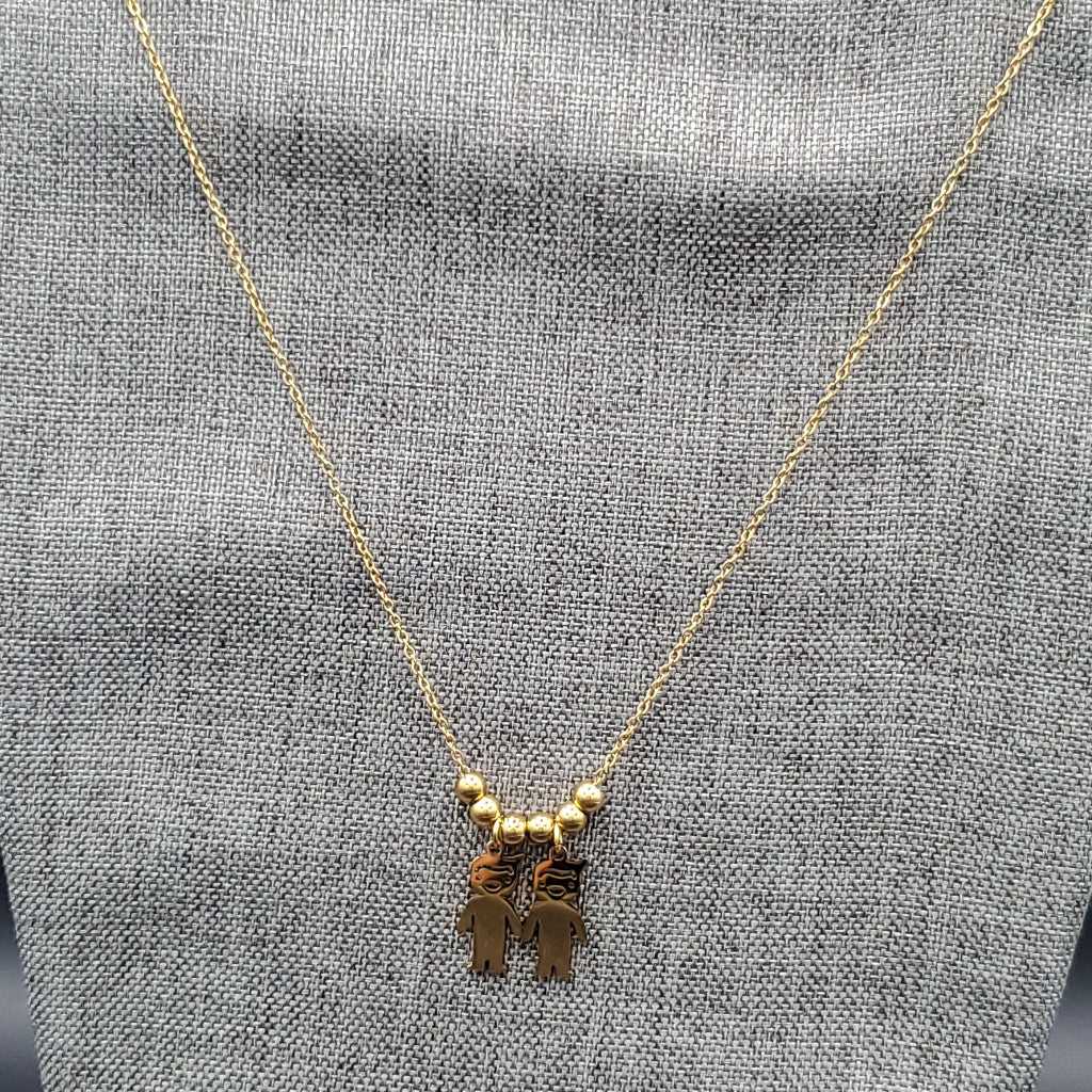 Boy & Girl Necklace in Gold finish on a neutral background