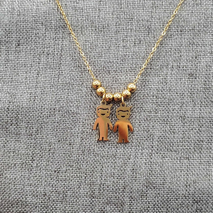 Boy & Girl Necklace in Gold finish on a neutral background