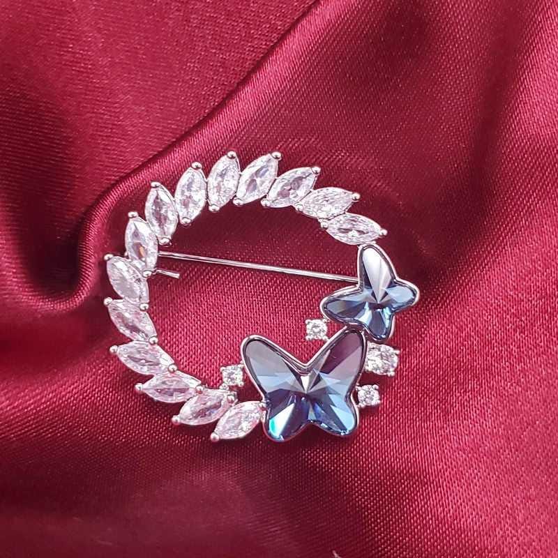 Classic Blue Butterfly Brooch in Silver finish, with cubic zirconia stone on a neutral background
