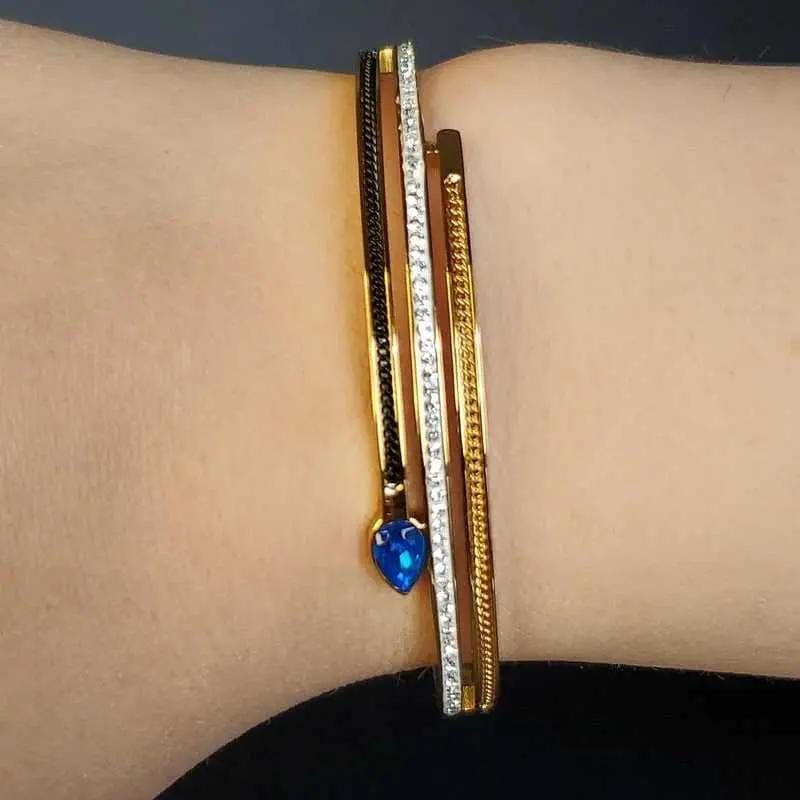 Classic Blue Teardrop Stone Bangle in Gold and Silver finish, with cubic zirconia stone on a neutral background