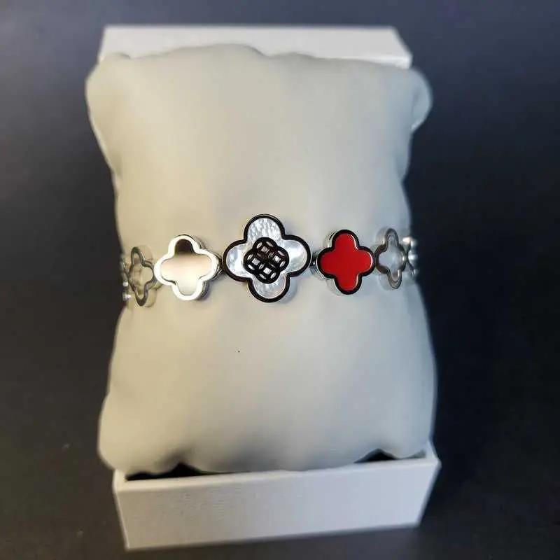 Classic Clover Bangle in Silver finish, with pearl stone on a neutral background