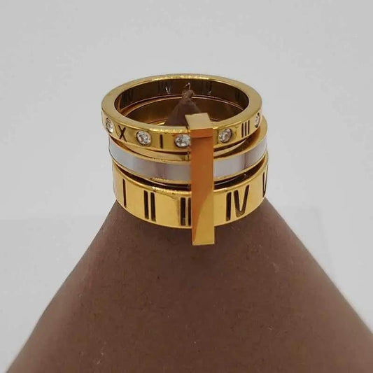 Classic Latin Number Ring in Gold and Silver finish, with cubic zirconia stone on a neutral background