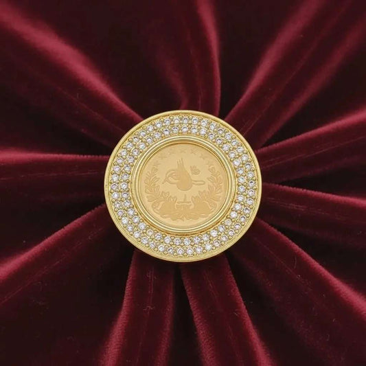 Classic Lira Coin Ring in Gold finish, with cubic zirconia stone on stones on a red velvet background