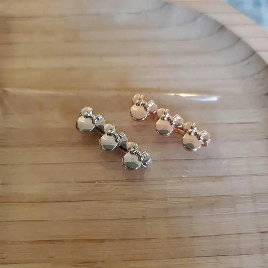 Classic Minnie Mouse Charms in Gold and Silver finish on a neutral background