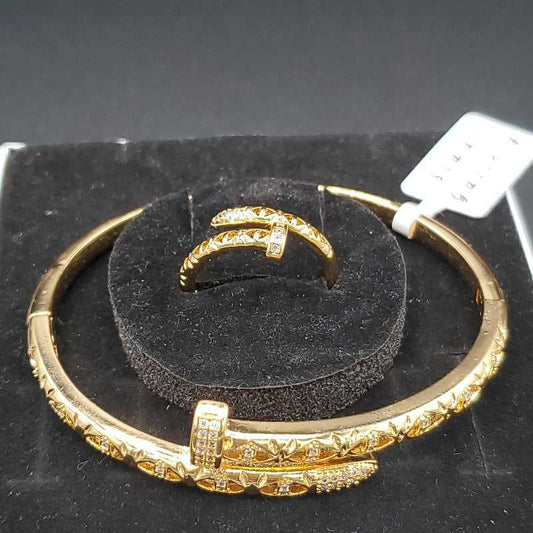 Classic Nail Bangle & Ring Set in Gold finish, with cubic zirconia stone on a neutral background