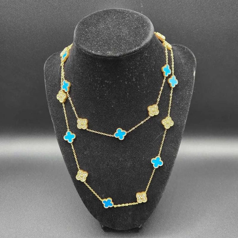 Clover Clover Necklace in Gold finish, with cubic zirconia stone on stones, modeled on a black bust