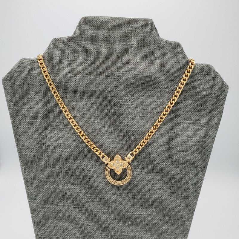 Clover Four Leaves Necklace in Gold finish, with cubic zirconia stone on a neutral background