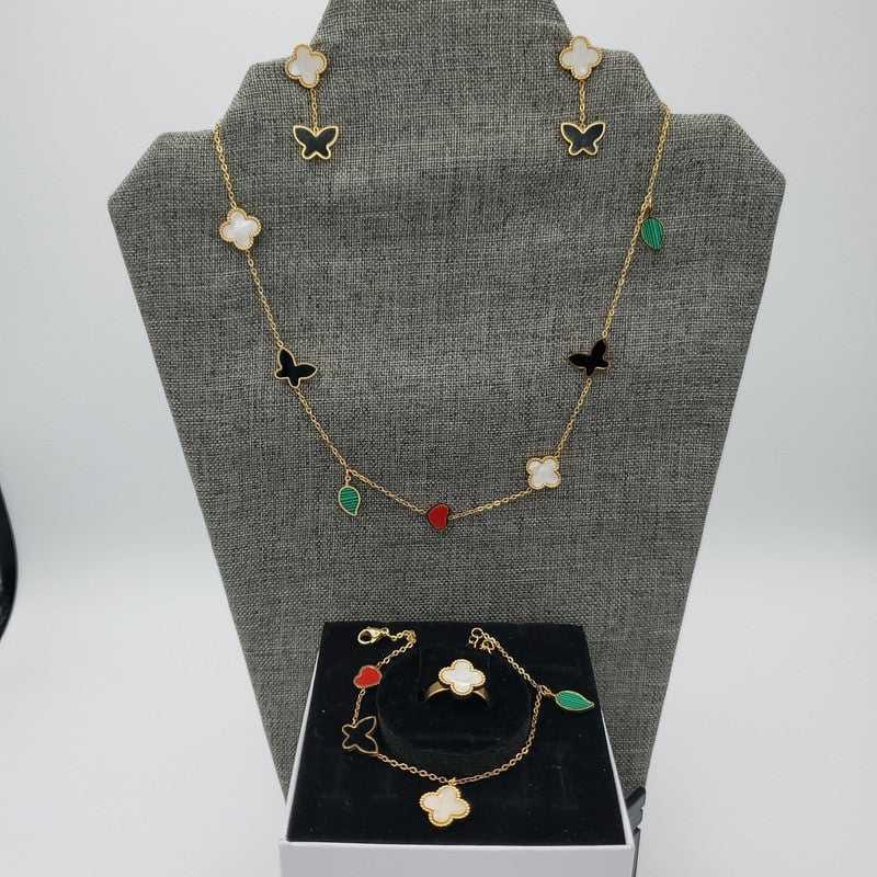 Colorful Butterfly Clover Set in Gold finish, with pearl stone on a neutral background
